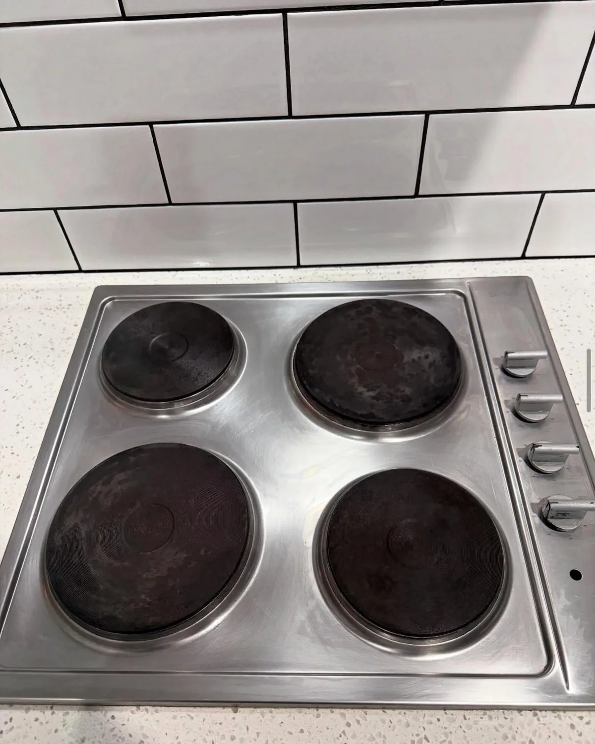 The same customer stovetop spotless and gleaming after an Oz SpotNest clean